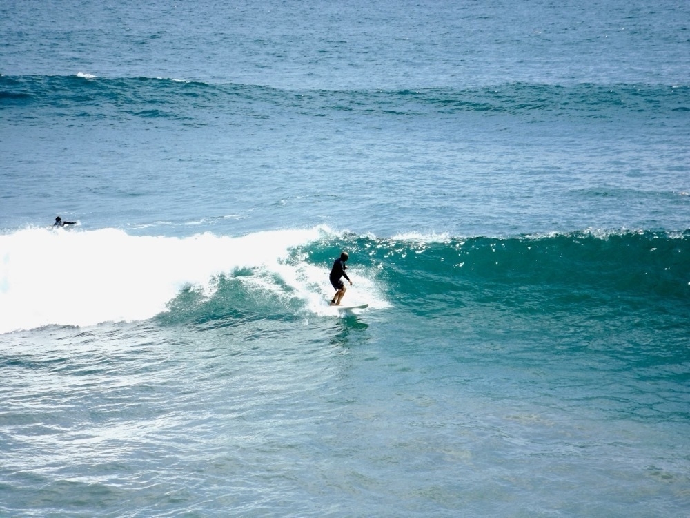 A lone surfer on a shoulder-high wave at Huntington Beach.